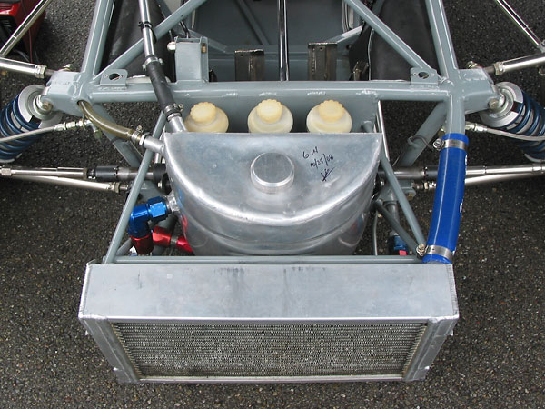 Nose-mounted aluminum engine oil reservoir tank.
