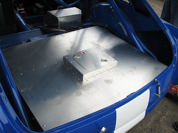 A twelve gallon ATL fuel cell is mounted under this fireproof aluminum cover...