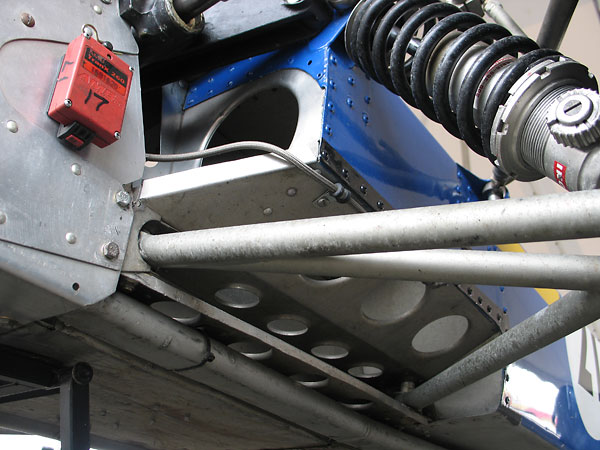 Aluminum coolant piping is routed below the lower-front suspension pickups (and also the fuel tanks).