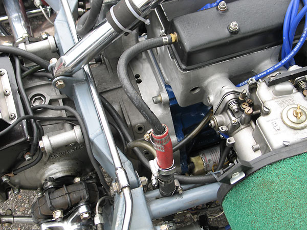 The engine's valve cover is vented through a chassis tube forward to the oil reservoir.