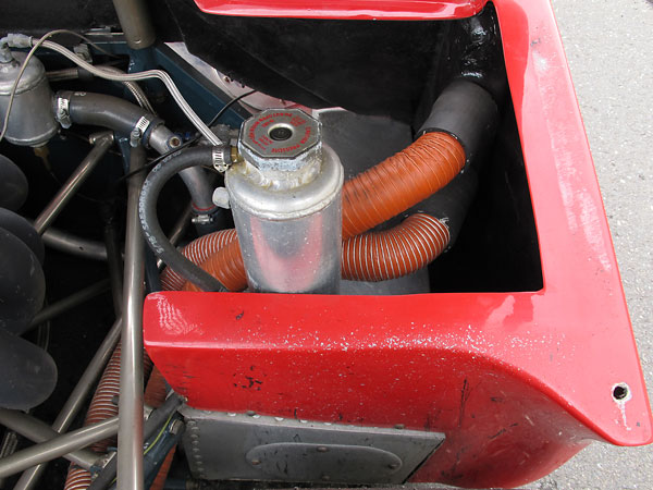 Custom aluminum coolant header tank. (Hoses in background are for brake cooling.)