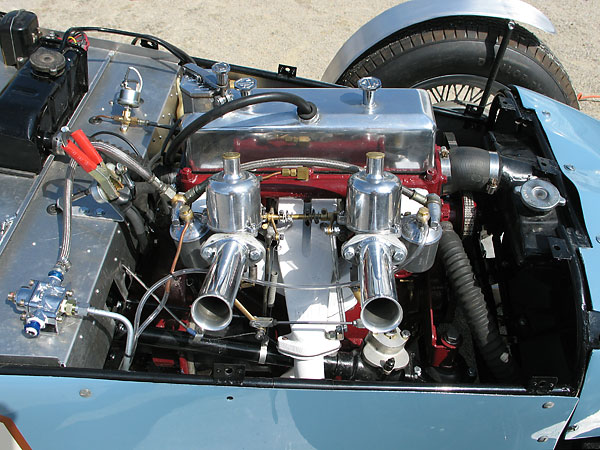 The steering gear can be seen underneath the forward carburetor.