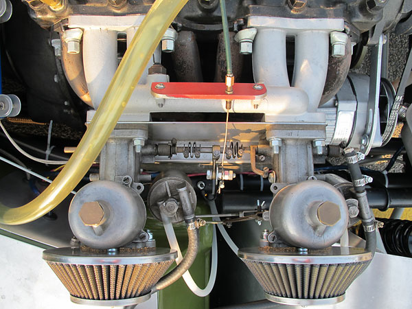 Dual S.U. H6 carburetors mounted on a Triumph TR4 aluminum intake manifold.