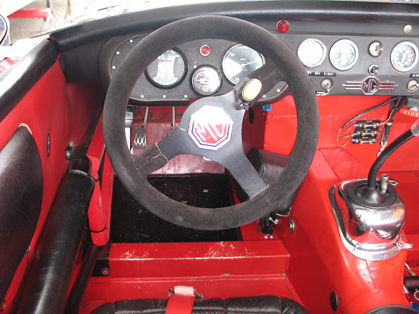 The yellow button on the Derek's Momo steering wheel is for his 2-way radio.