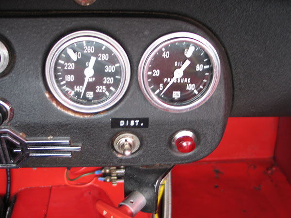 Stewart Warner oil temperature (140-325F) and oil pressure (5-100psi) gauges.