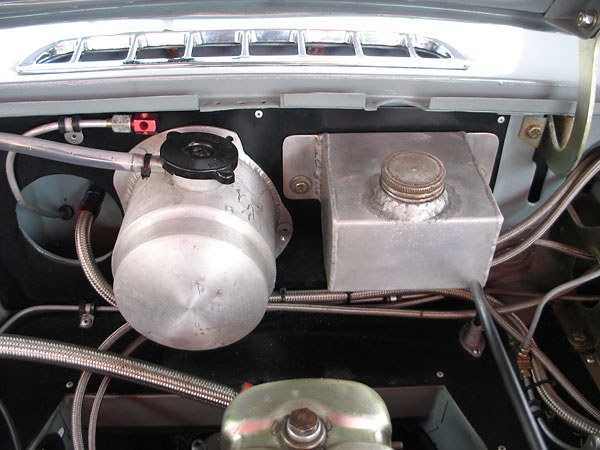 Coolant overflow tank (left) and brake system fluid reservoir (right).