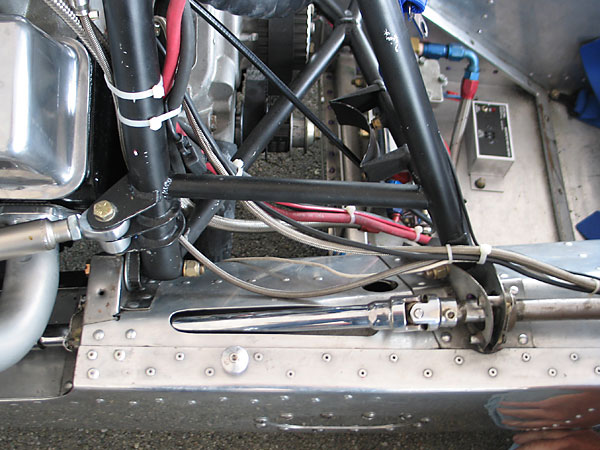 The gear selector linkage is routed through a hole in the aluminum monocoque tub.