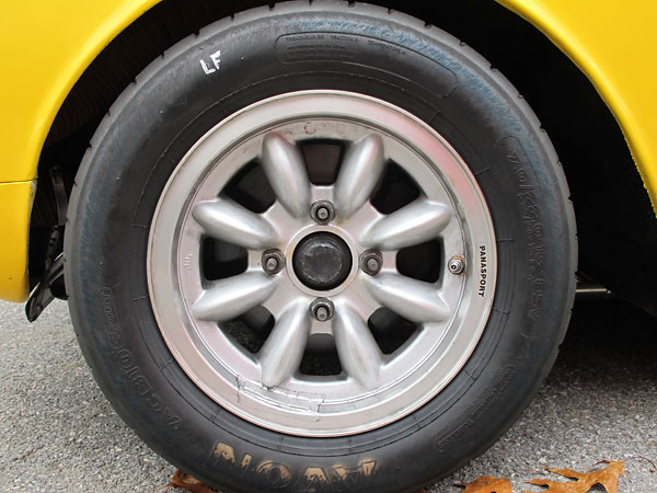 Panasport 8-spoke 6x13 aluminum wheels with Avon AC B10 Sport 215/50/13 85V tires.
