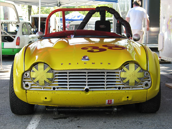 Triumph TR-4 engines didn't come with manual starters, but the front grilles have holes for them anyway.