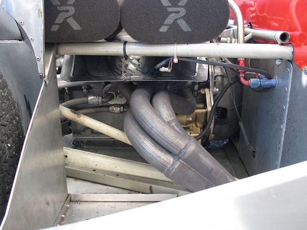 Between exhaust and carburetors, we can see an aluminum heat shield. Below, a Tilton Super Starter.