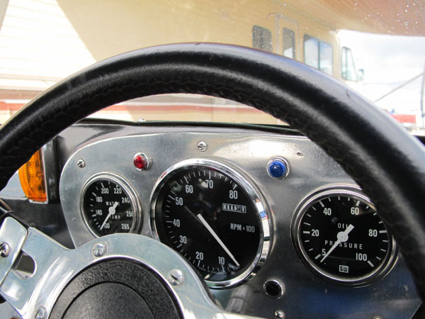 Stewart Warner water temperature and oil pressure gauges surround an Elliot tachometer (0-8000rpm).