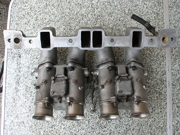 Bottom of the John Eales swan neck manifolds and Weber carburetors.