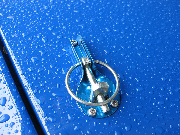 Slide type captive hood pin assembly with stainless steel retainer plate.