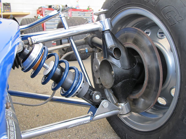 Lola proprietary fabricated steel front uprights featuring live stub axles.