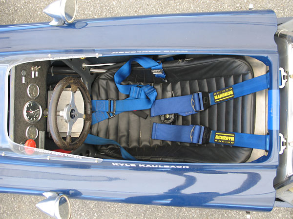 A comfortable looking seat, and a Schroth Racing six-point cam-lock safety harness.