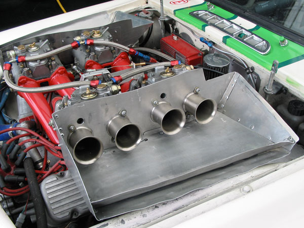 On this race engine, the carburetors are fitted with velocity stacks in lieu of air filters.