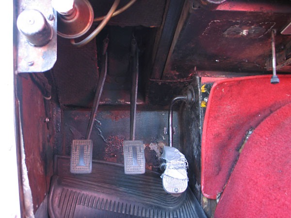The Paddy Hopkirk style throttle pedal is connected to the carburetors through a mechanical linkage.