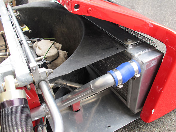 After passing through the radiator, airflow exhausts to the sides.