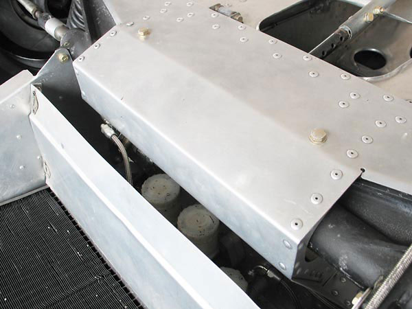Lockheed master cylinders with integral reservoirs are accessible by removing the panel.