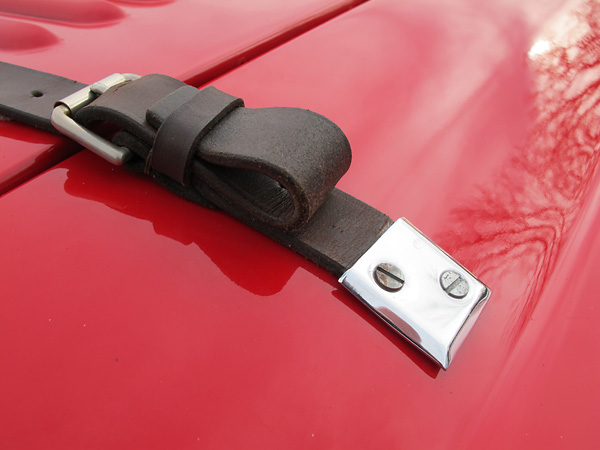 Leather bonnet hold-down straps.