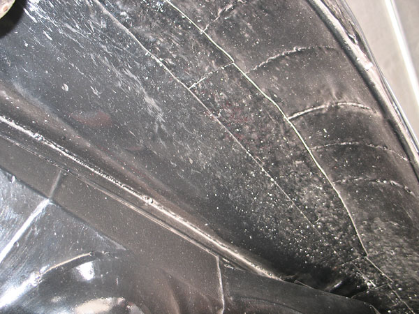 Wasp-waisted front fender: from inside you can see where steel was added along the top of the fender.