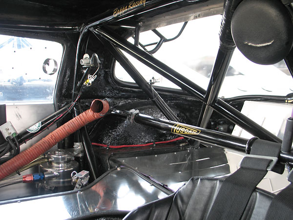 Shoulder harness straps wrap around a well-placed roll cage bar.