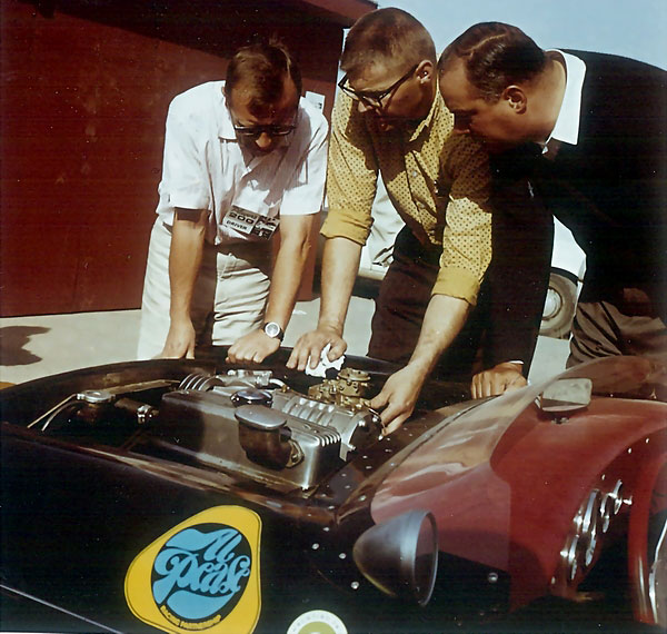 John Camden (center) helps Al Pease (left) dial in the Carter carburetor for the 1964 Player's 200 race.