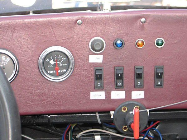 Start pushbuttom. Left-to-right: Ignition, Fuel, and Light rocker switches.