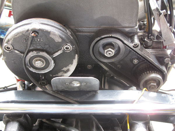 Left: an alternator. Right: belt drive for the Lucas mechanical fuel injection metering unit.