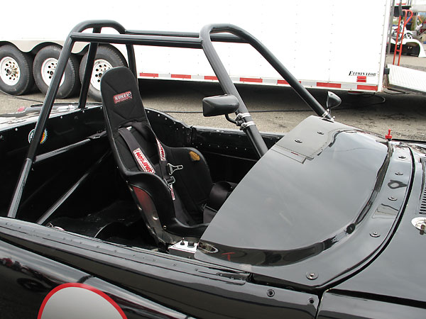 Molded low-profile plastic windscreen in lieu of the original windshield.