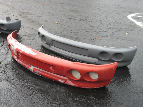 An original (slightly damaged) MG RV8 front bumper, and a fiberglass replica made from it.