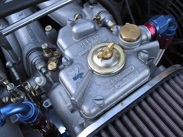 Close-up view of one of the three Weber 40DCOE 151 carburetors.