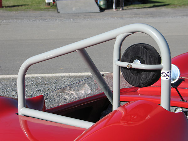 The well-braced rollover hoop and headrest are modern additions, as required for vintage racing.