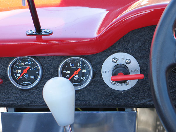 Autometer Sports Comp oil temperature gauge (140-280F) and oil pressure gauge (0-100psi).
