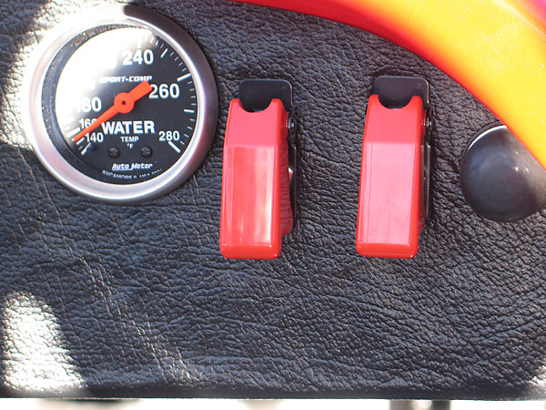 Ignition and fuel pump toggle switches, with safety covers.