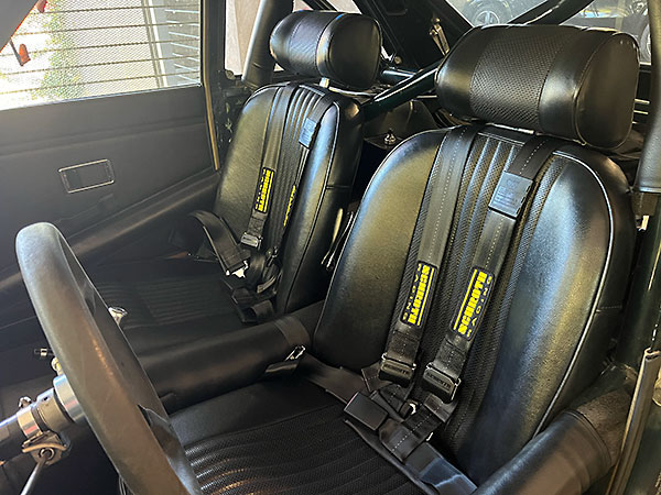 Schroth Rallye Cross ASM 2-inch safety harnesses with bolt-in lap belts and wrapped shoulder belts.